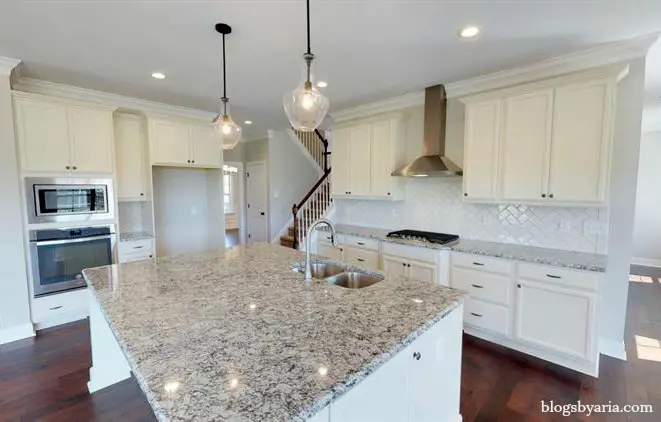 white kitchen with granite counter tops
