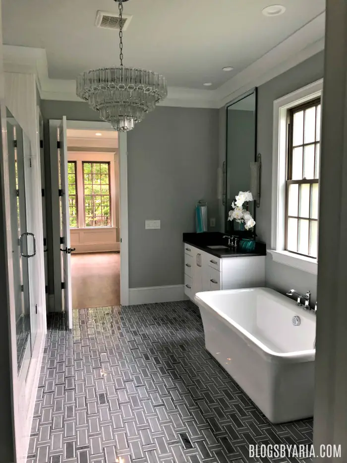 gray master bathroom with chandelier