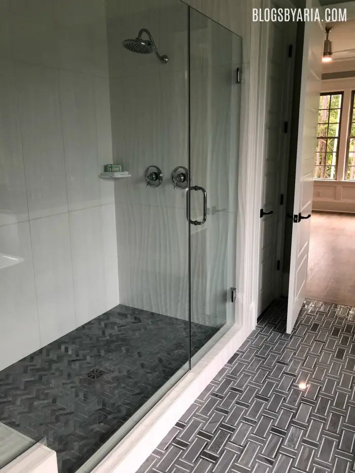 I love the gray tile flooring and the textured shower walls