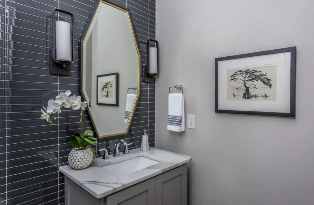 powder room with glass tile accent wall