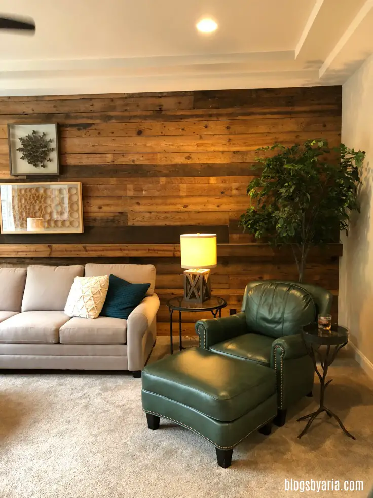 living space featuring reclaimed wood plank wall