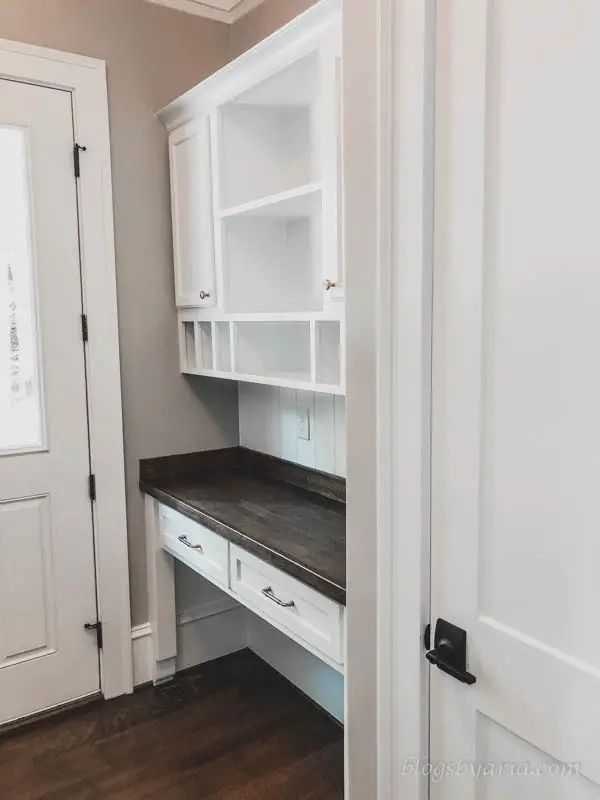 the mudroom also features a built-in desk command center