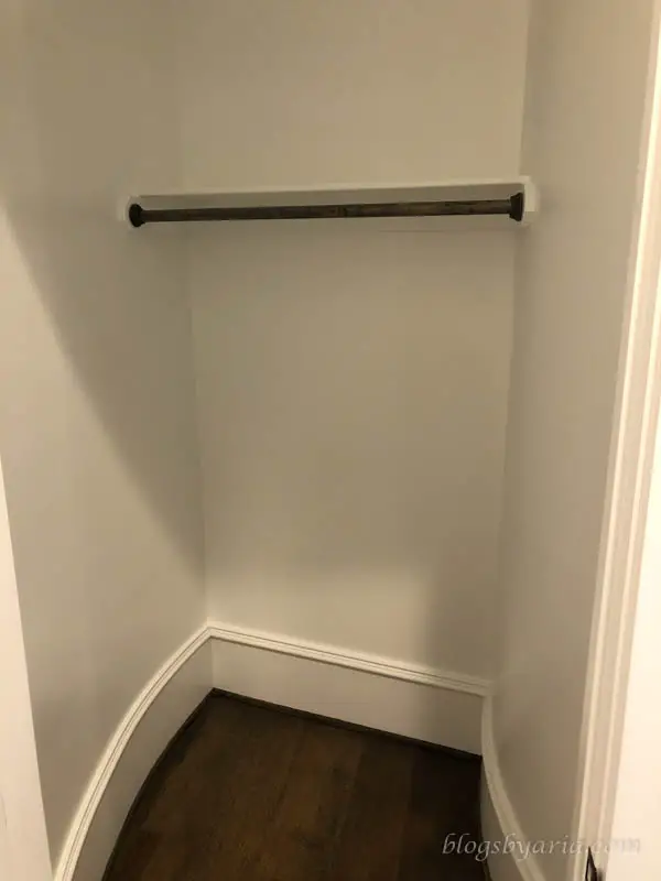 coat closet under curved staircase