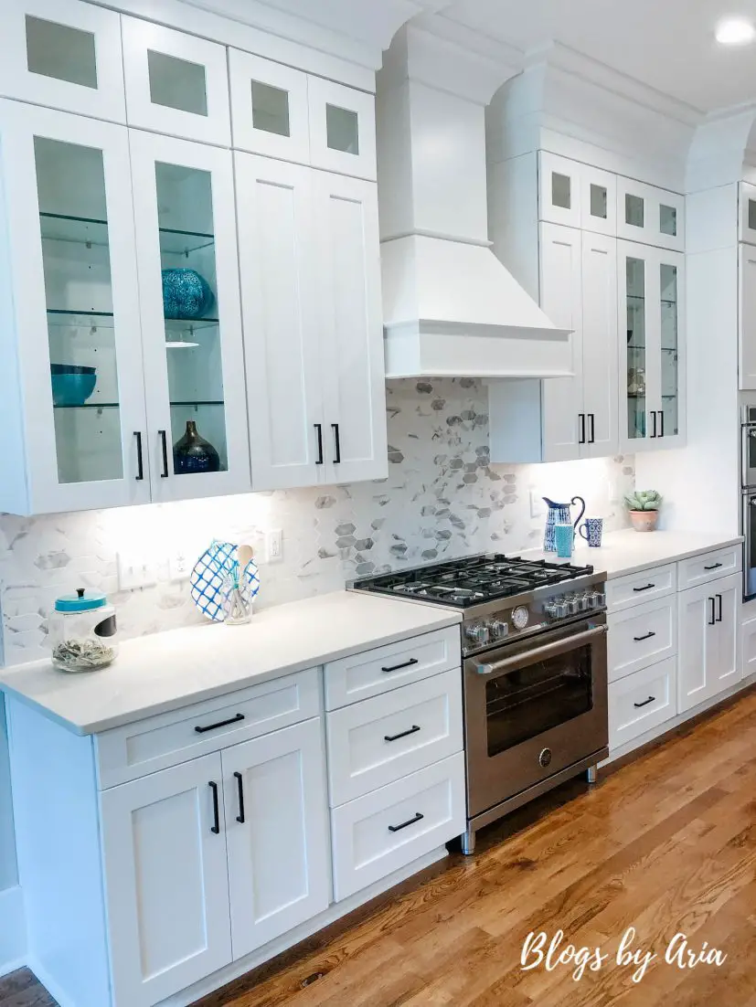 white kitchen with glass shelves for display