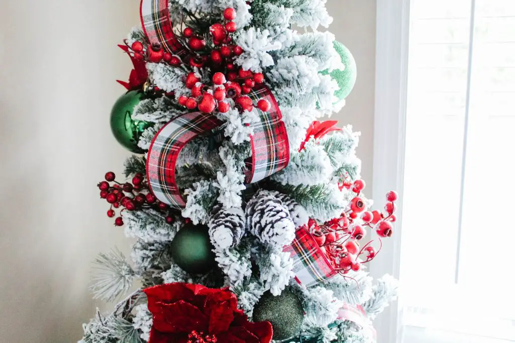 decorating a flocked Christmas tree