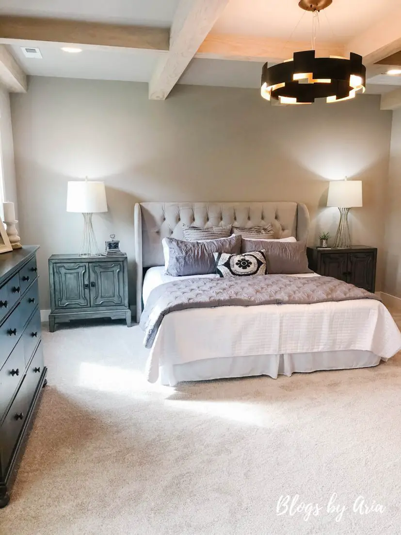 modern farmhouse bedroom with stained wood coffered ceilings and black lighting