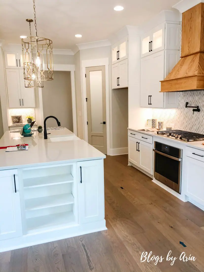 modern farmhouse kitchen with wood stained range hood